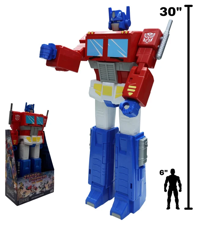 Big-Figs Optimus Prime shown beside a 30 inch scale bar and a 6 inch human silhouette, with the boxed product in its Transformers The Movie window tray at left