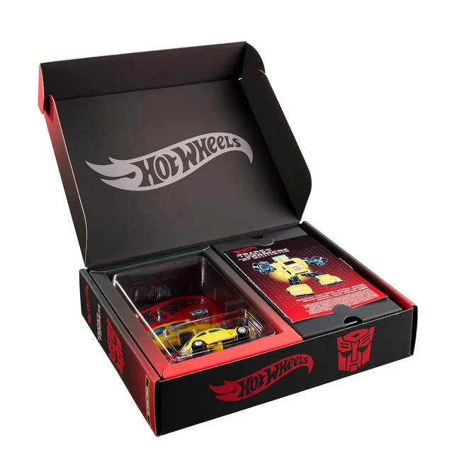 The open Hot Wheels Transformers Bumblebee mailer box, with the die-cast car sealed in a blister on a retro Hot Wheels card on the left and a printed conversion instruction sheet on the right.