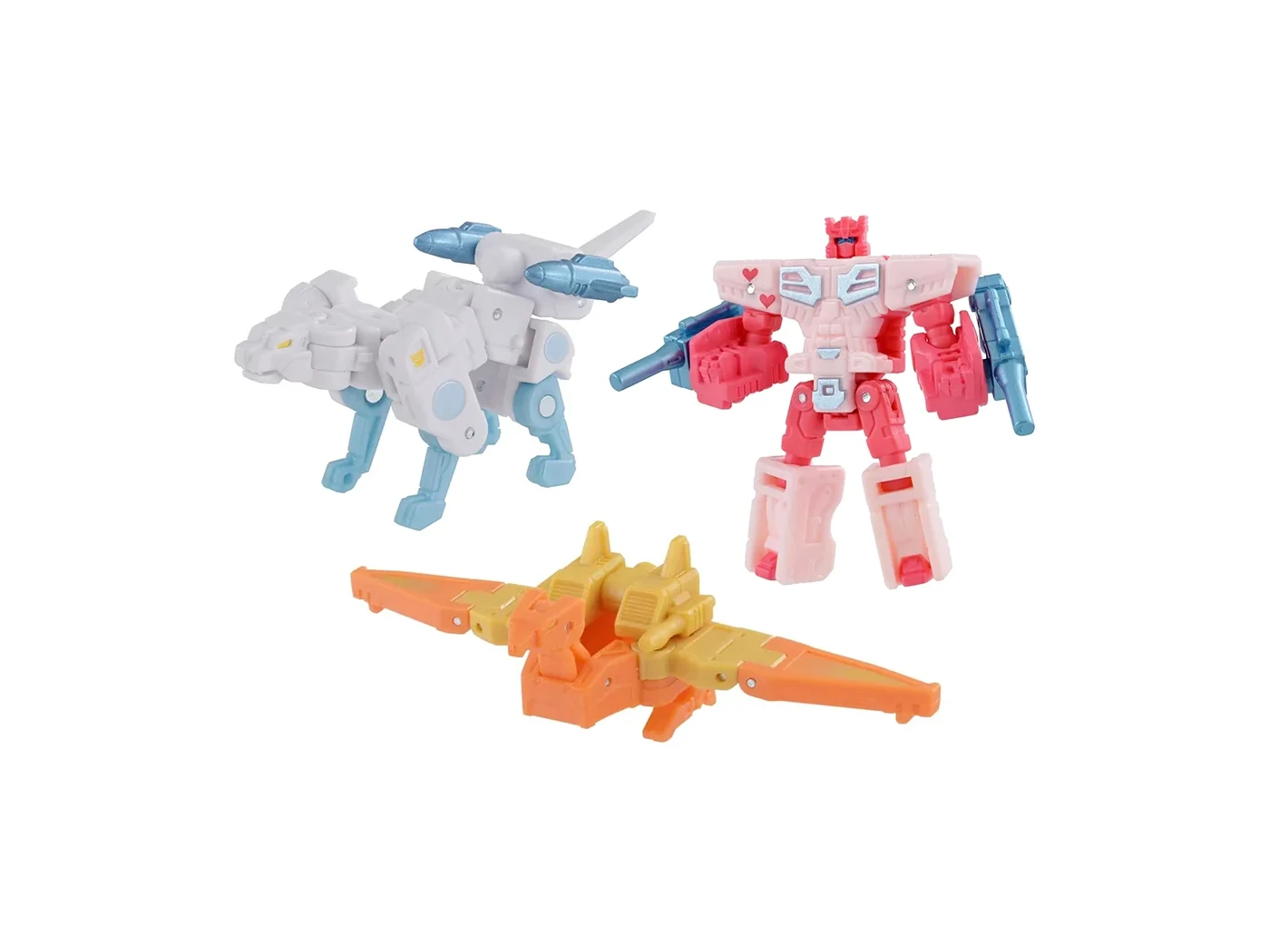 Three small Cassettebots on white: a white and blue wolf, a pink and white robot with heart markings, and an orange and yellow bird