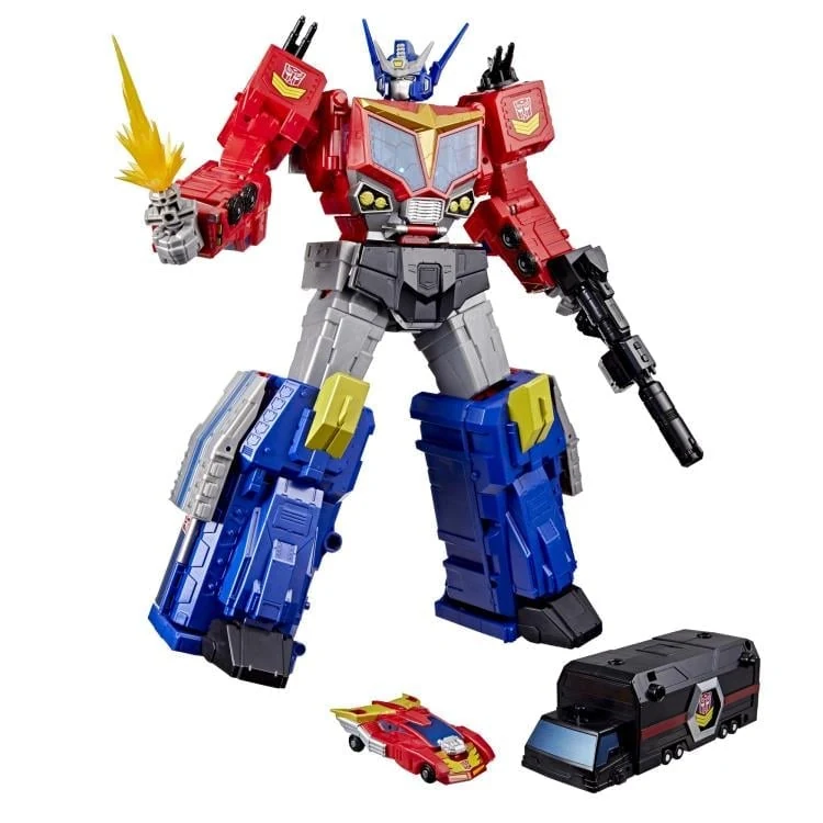 Hasbro Transformers Age of the Primes Titan Class Star Optimus Prime action figure in robot mode, holding a rifle and a weapon with a yellow energy effect, shown with the included Micromaster Autobot Hot Rod car and the black MT-13 Microtrailer