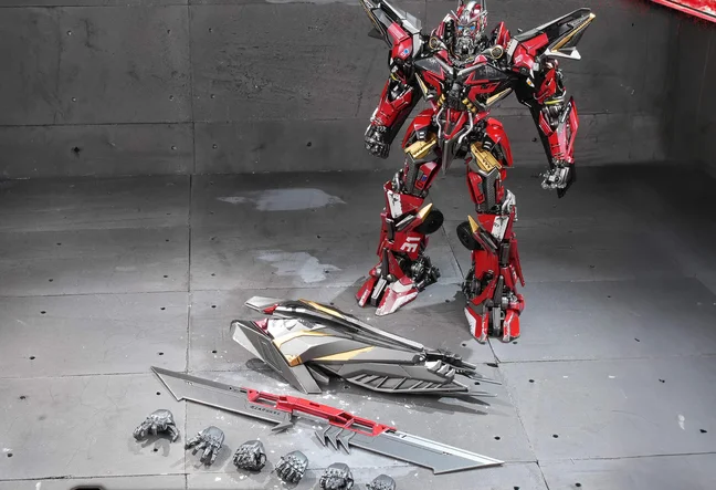 Sentinel Prime with his shield, the Primax Blade separated into two halves, and the interchangeable hands laid out on the floor beside him.