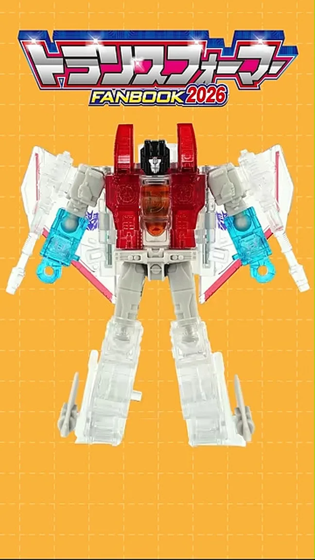 The Kodansha Transformers Fanbook 2026 bonus figure in robot mode, a partially clear redeco of Starscream with a red chest, grey limbs, translucent wings and legs, and light blue null-ray cannons, posed against an orange grid backdrop under the Transformers Fanbook 2026 logo