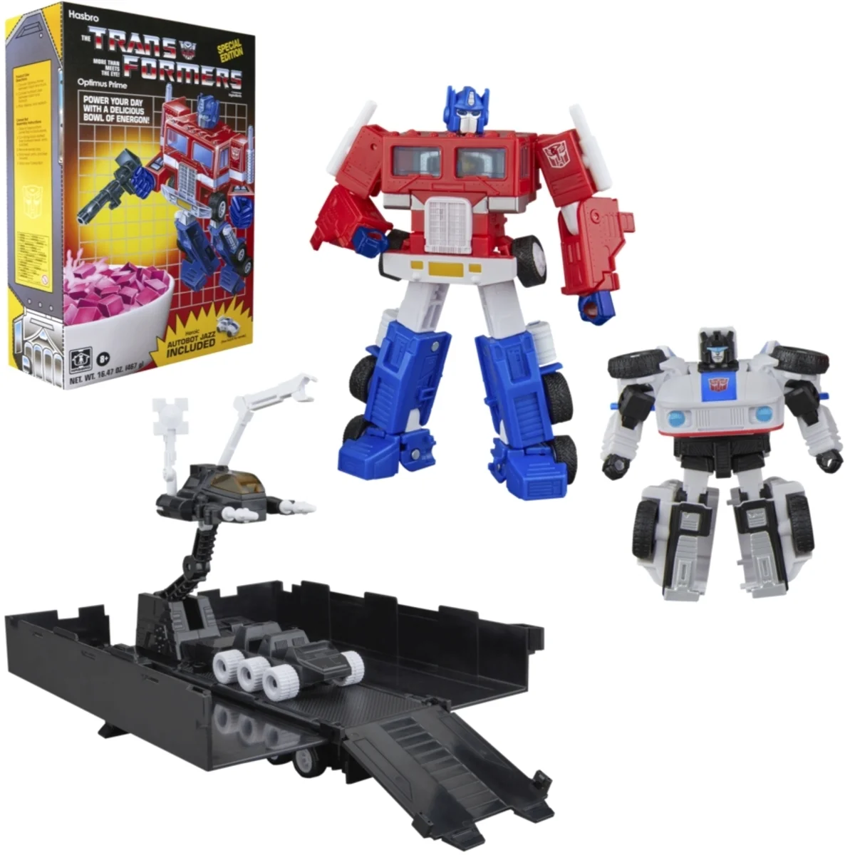 The SDCC 2026 exclusive Optimus Prime and Autobot Jazz cereal box set, showing the retro Transformers cereal packaging, a red and blue Optimus Prime figure with blaster, a black and white Autobot Jazz figure, and the trailer opened into its combat deck and repair bay