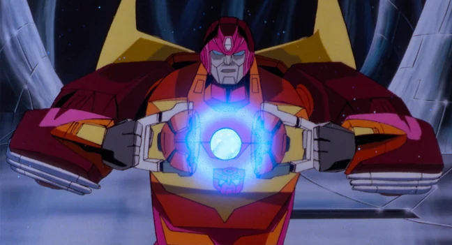 Still from the 1986 animated film The Transformers: The Movie showing Rodimus Prime with his chest panels open and the Matrix of Leadership glowing blue at the centre of his body